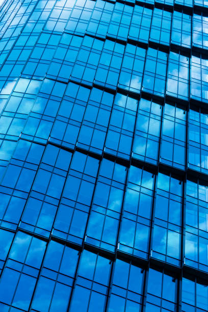 istock architectural abstracts: office building glass facade with reflected clouds 1710095329