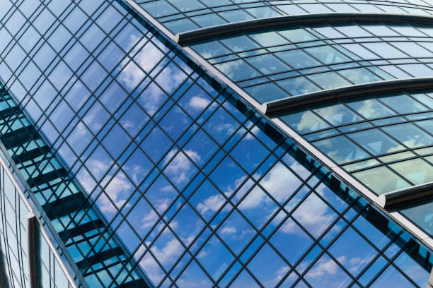 istock architectural abstracts: office building glass facade with reflected clouds 1710095393