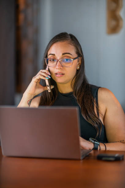 istock Woman working on computer at home, at desk while wearing glasses 1710098729