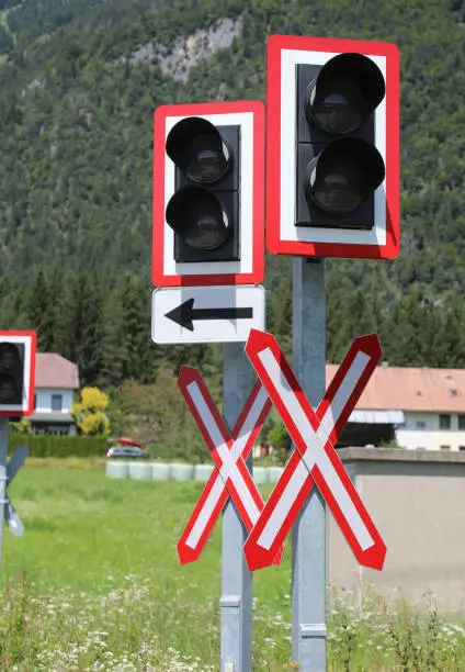 many road signs of attention to the train level crossing on the rails of the railway