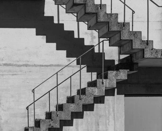 istock Abstract architecture background, square concrete stairway perspective, stairwell, black and white photo. 1710142465