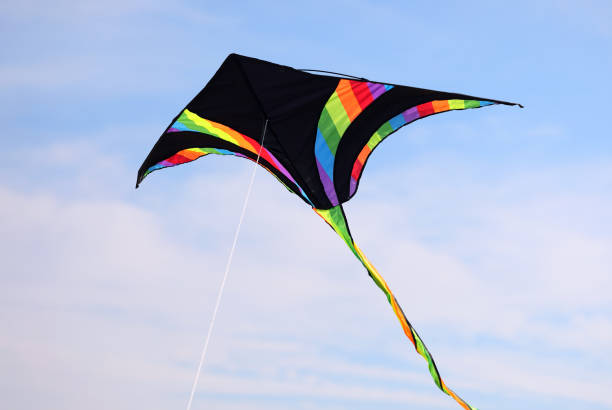 istock multicolored kite with black inserts flying free in the sky 1710142515