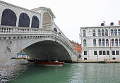 Rialto bridge with few boats and without people during the lockdown inflicted by the pandemic