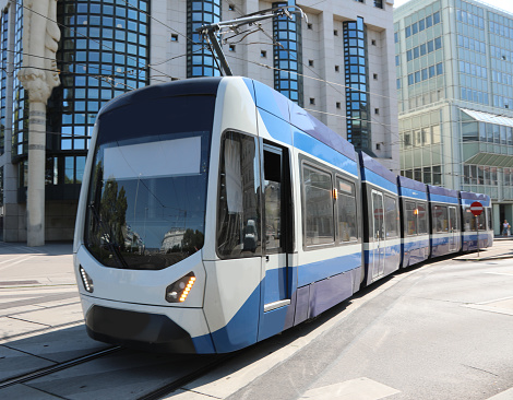 blue and white modrn tram on rails for transporting people in the metropolis