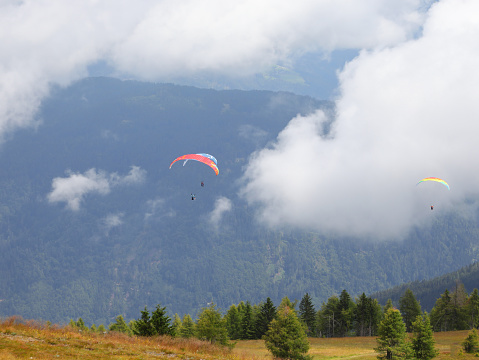 some paragliders even have two people flying at the same time in the clouds in the mountains