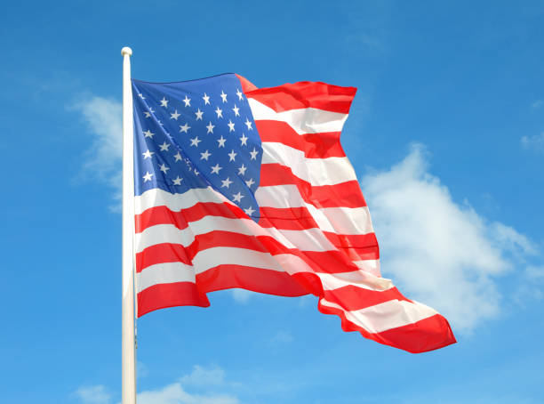 istock US Flag waving in the wind and blue sky 1710187715