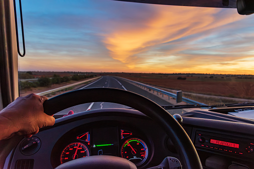 View from inside a truck of an empty highway.