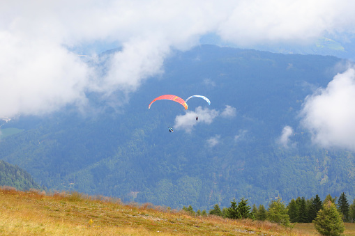 paragliding with two people on board for a couple flight and the clouds in the high mountains