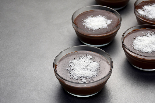Chocolate pudding with coconut powder in bowls, dessert, chocolate mousse