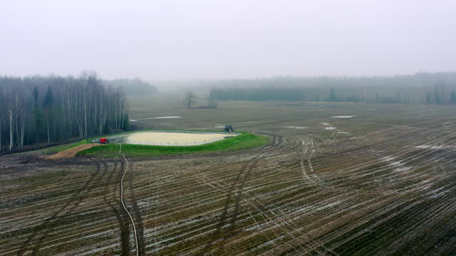 Aerial view of Agricultural land in autumn. Cultivated agricultural land. Liquid manure pond.