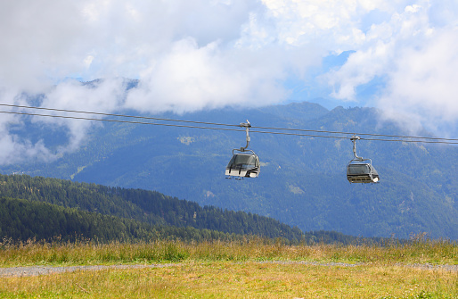 two chairlift cabins to transport hikers to the high mountains without effort in summer