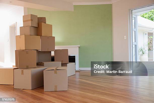 Boxes Stacked In Living Room Of New House Stock Photo - Download Image Now - Relocation, Cardboard Box, Anticipation