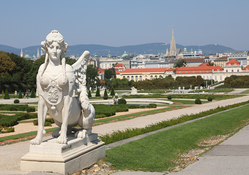 Vienna, WIEN, Austria - August 22, 2023: Ancient Palace called Belvedere and white statue of Sphinx and Gardens