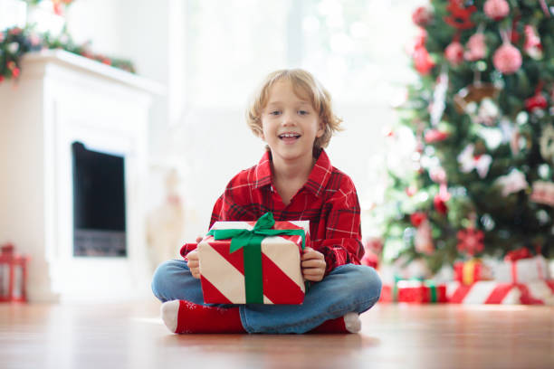 istock Child at Christmas tree. Kids at fireplace on Xmas 1710230003