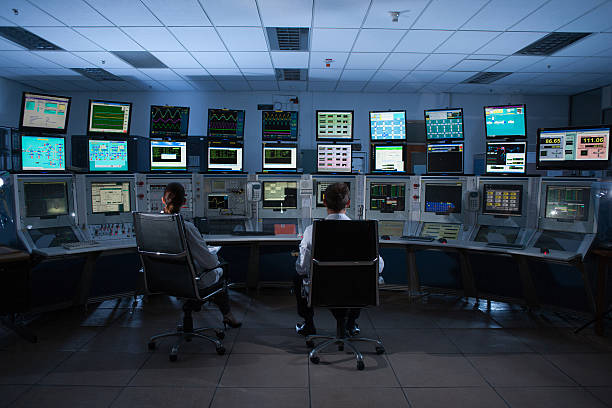 Scientists monitoring computers in control room  control room photos stock pictures, royalty-free photos & images