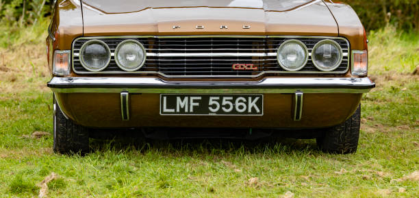 Newcastle-under-Lyme, Staffordshire-united kingdom April, 14, 2023  Front view on gold, brown Ford Cortina GXL Mk3 from 1970s