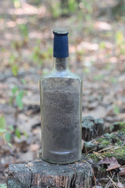 istock one big dirty gray glass bottle stands on a table 1710380911