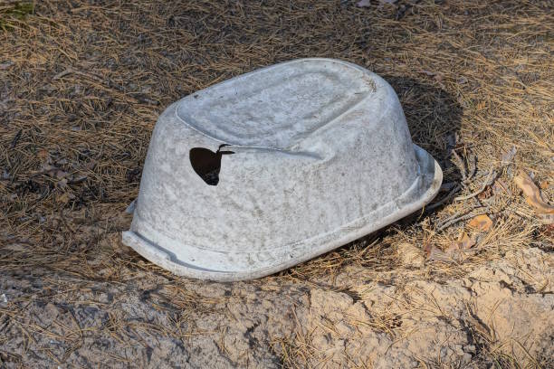 istock one old white dirty broken plastic basin, a trough with a hole 1710385848