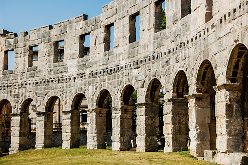 Pula, Croatia - June 1, 2019: Walls of the ruins of the Pula Coliseum.