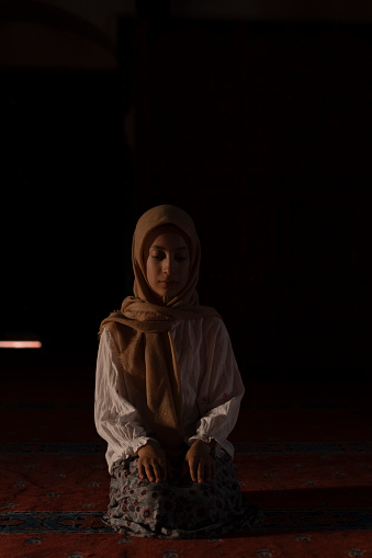 Girl child praying in mosque. child praying in mosque. Worship during Ramadan. Islamic life.