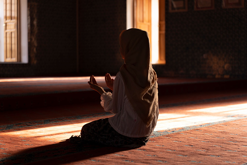 Girl child praying in mosque. child praying in mosque. Worship during Ramadan. Islamic life.