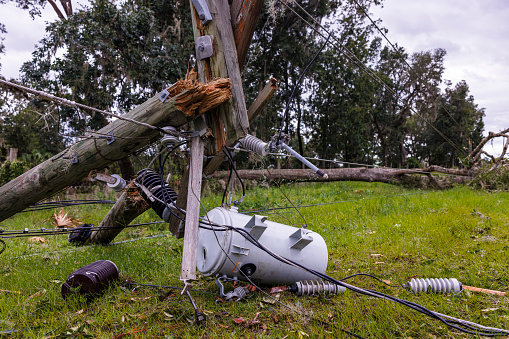 Aftermath of natural disaster: broken telephone poles and damaged electric fuse box after storm in Steinhatchee, North Florida.