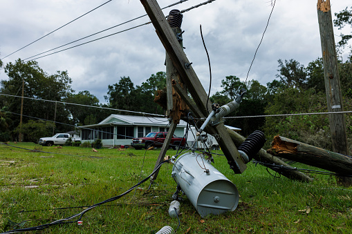 Power supply problems after hurricane: fallen and tilted electric poles in the vicinity of residential Steinhatchee, North Florida