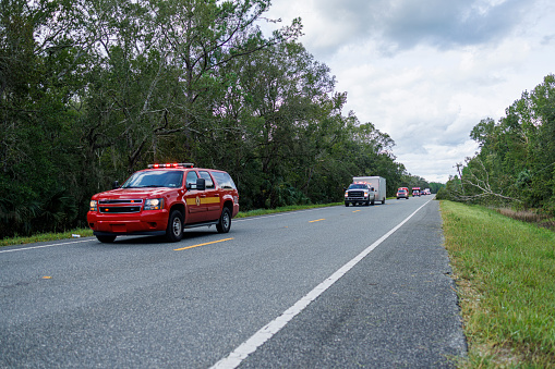 Ambulance cars battling storm aftermath on the road: convoy of rescue cars mobilize in North Florida