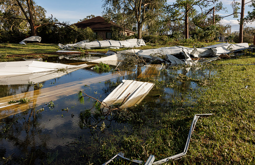 Store building devastation in flood after storm: twisted metal constructions aftermath in Perry, North Florida