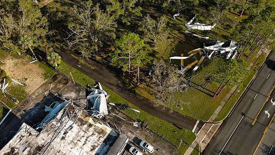 Shop building in ruins in North Florida: Roof torn away, debris scattered after hurricane fury in Perry, FL. Aerial view