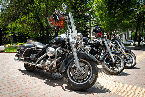 Bikes in a row. several large American Harley Davidson motorcycles stand in a row in the parking lot, Almaty, Kazakhstan. May 26, 2023