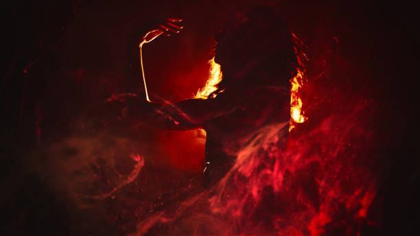 istock Fire dance woman silhouette red smoke spot light 1710516917