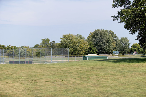 Baseball diamond and dugout await players on a late summer afternoon