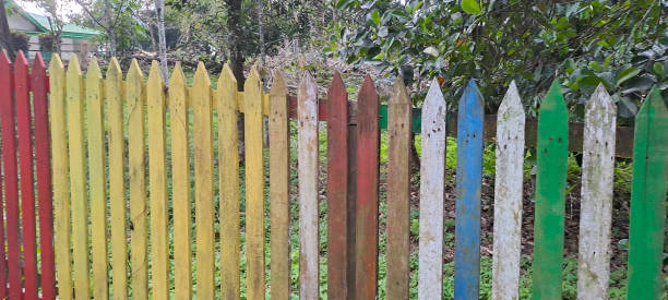 istock Multi colored rainbow wooden fence in garden background 1710519746