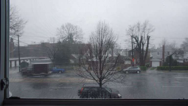 The view from the window of a road with cars on a rainy day in Queens, New York, USA.