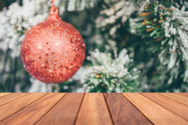 istock Empty wood table top with blur Christmas tree with bokeh light background 1710520947