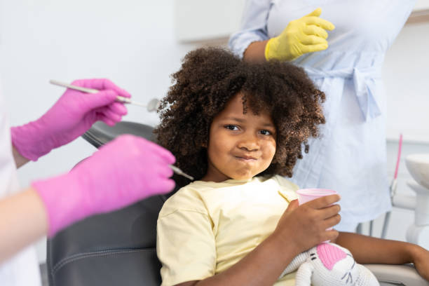 istock A pediatric dentist works with children 1710522801