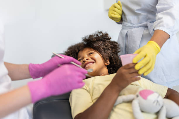 istock A pediatric dentist works with children 1710522804