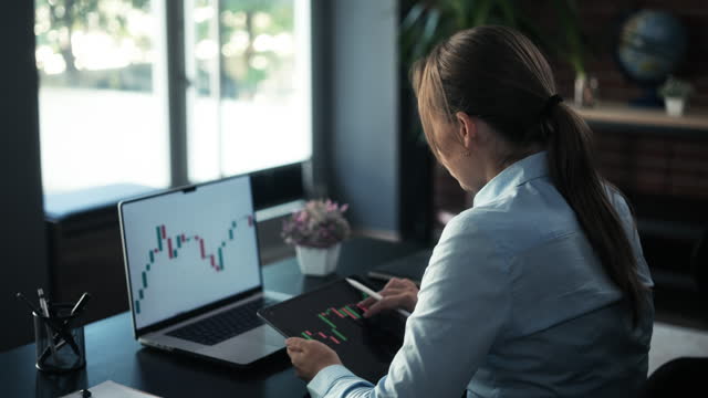 Entrepreneur Woman Checking Her Stock Market Investment Using Laptop Computer