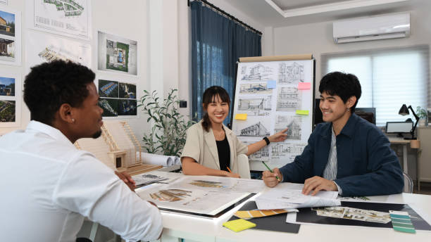 istock A team consisting of a young architecture engineer and a businessman collaborate to design a new home. 1710525385