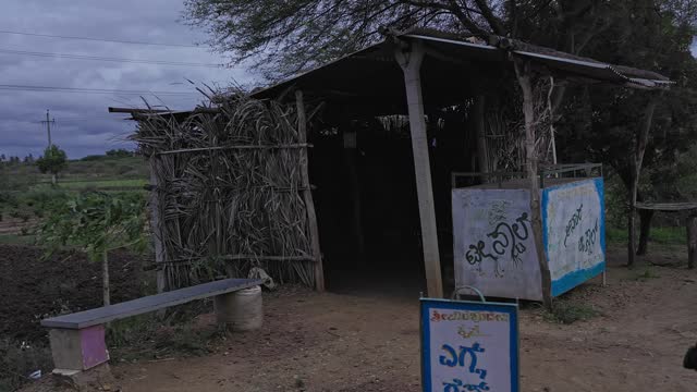 An old-style temporary roadside hotel built from palm branches on the highway