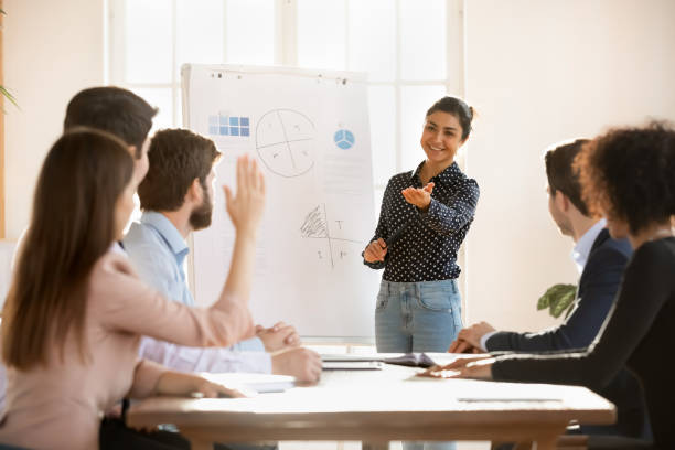 istock Smiling ethnic female coach interact with employee at meeting 1710527774