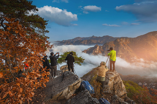 Dangyang - gun, Chungcheongbuk-do, South Korea - October 31, 2020: Photographer taking photos of the sea of mist in the morning at Jebibong Peak. Waraksan Mountain In Waraksan National Park near  Danyang-gun, South Korea. on October 31, 2020.