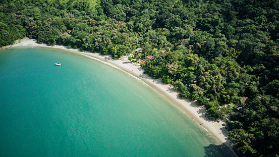 Beach landscape on a sunny day, seen from above, drone photography, calm turquoise waters, with a small island in the foreground, mountains with forest, Praia da Justa, Ubatuba - Sao Paulo - Brasil