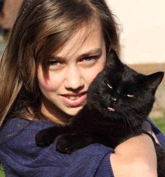 istock young girl with black  cat 171056772