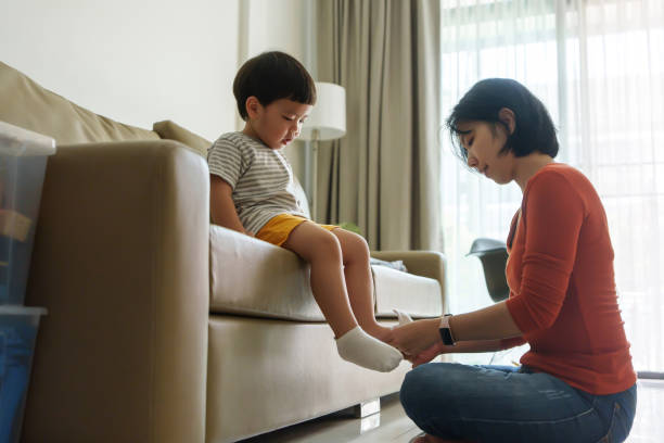 istock Asian Mother putting socks on her son 1710609153