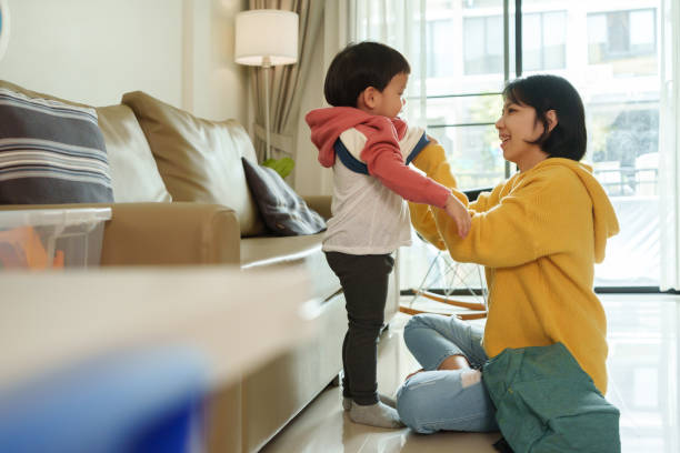 Asian Chinese Mother dressing her Son