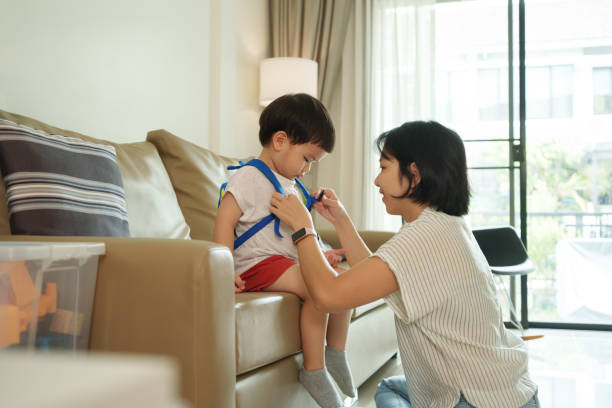 istock Asian mother adjusting son to fasten buckle on backpack 1710609408