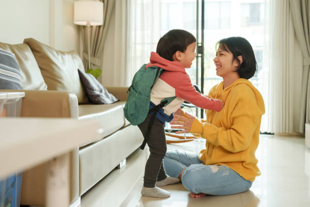 istock Asian little son in backpack playing with his Mother 1710609448