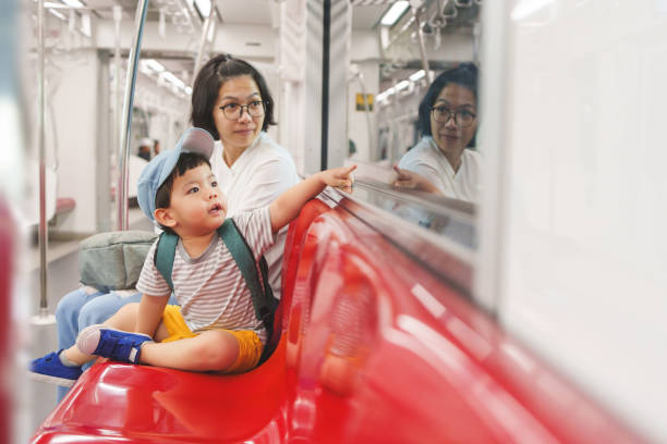 Asian mother and son traveling by commuter train.